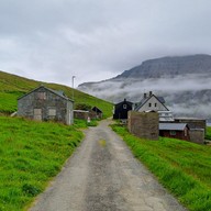 Road leading to abandoned village, buildings visible