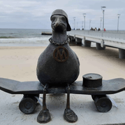sculpture of a seagull with a skateboard
