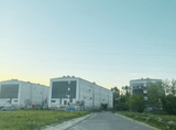 road leading to an abandoned housing estate consisting of three blocks of flats