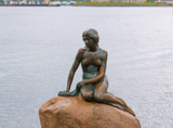 statue of a naked woman on a rock