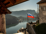 urban development by the lake and the flag of Slovenia