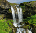 view of falling water from a waterfall among mountain rocks
