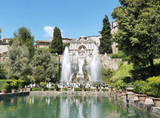high fountains among vegetation and buildings