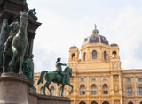 sculptures with people on horses, in the background a truncheon with numerous decorations