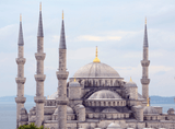 building under a dome with four towers