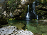 waterfall among rock massifs