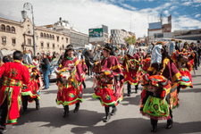 People on the street in traditional costumes with bull dummies