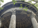 mausoleum under a dome with columns in the forest