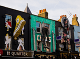 colourful buildings decorated with clothing and pop culture figures