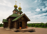 a wooden log church with two turrets