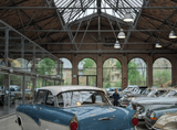 car models in a glazed brick building