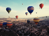 balloons over the city amid the mountains