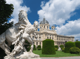 marble sculpture of a horse and a man, in the background a palace with a dome