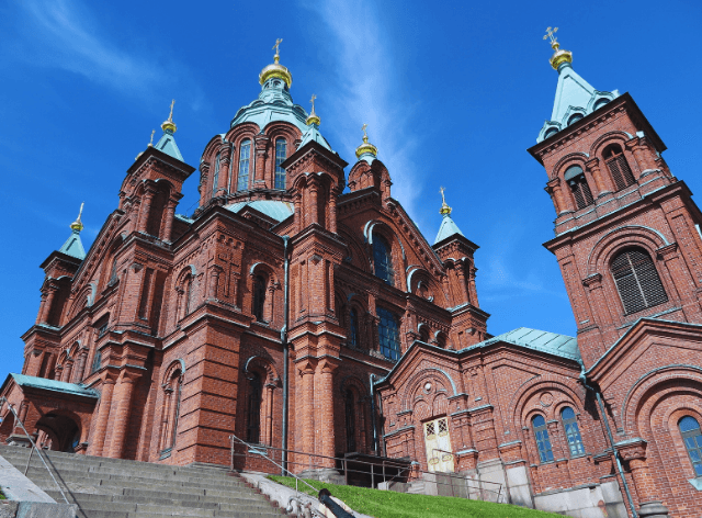 tall brick building with numerous turrets