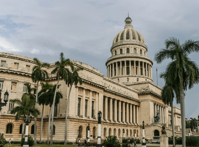 rectangular parliament building with a large dome and a spike