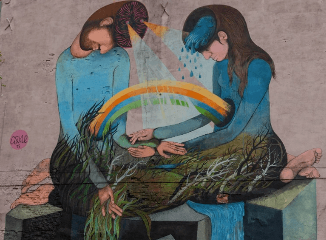 mural przedstawiający siedzące dwie postaci